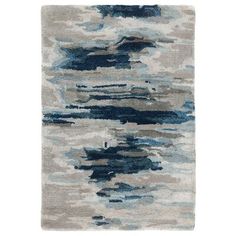 a rug with blue and gray paint on it, in the shape of an abstract painting