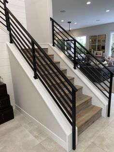 there is a stair case in the middle of this room with white walls and flooring