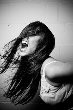 a woman with her hair blowing in the wind