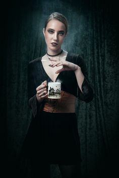 a woman holding a cake in front of her face with the shape of a heart