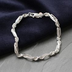 PRODUCT DESCRIPTION * Our Men's Sterling Silver Figaro Rope Chain Bracelet is the perfect addition to any man's jewellery collection. * Crafted from high-quality sterling silver, this chunky rope chain bracelet features a stylish twisted design that adds a unique touch. * It's the perfect gift for any occasion, including Father's Day, a birthday, or an anniversary. * Whether worn alone or paired with other accessories, this men's silver bracelet offers both sophistication and versatility.  * Thi Silver Bracelets For Men Unique, Men Silver Bracelet, Silver Bracelets For Men, Streetwear Jewelry, Mens Chain Bracelet, Boys Jewelry, Twisted Bracelet, Mens Bracelet Silver, Figaro Chain