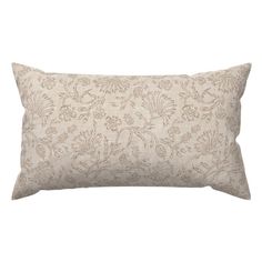 a white and gold pillow with an intricate pattern