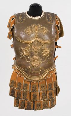 an elaborately decorated leather armor with gold trimmings on the chest and shoulders