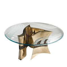 a glass and metal coffee table with an abstract design