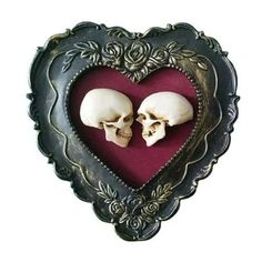 two skulls in a heart shaped frame