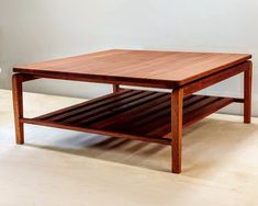 a wooden coffee table sitting on top of a hard wood floor