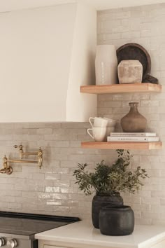 the kitchen counter is clean and ready to be used as a shelf for pots, mugs, and other items