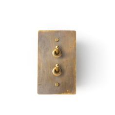 an old metal switch plate with two knobs on each side and three screws in the middle