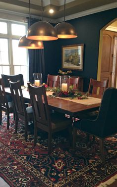 the dining room table is set with candles and place settings for four people to sit at