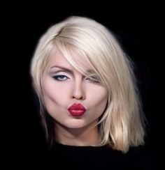 a woman with blonde hair and red lipstick on her lips is looking at the camera