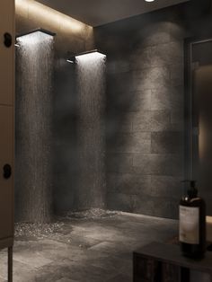 an image of a bathroom setting with shower head and lights on the side of the room