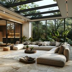 a modern living room with large windows and lots of furniture in the middle of it