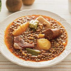 a white plate topped with beans and meat