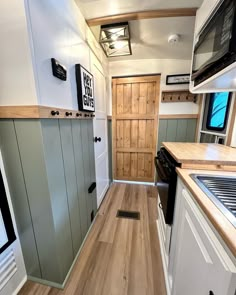 the interior of a tiny home with wood flooring