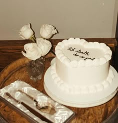 a white cake sitting on top of a wooden table