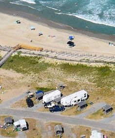 an aerial view of the beach with rvs parked on it's shore line