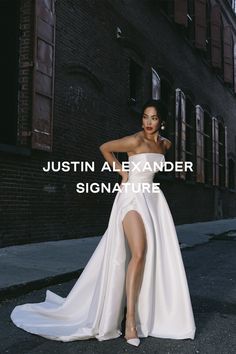 a woman in a white dress standing on the street