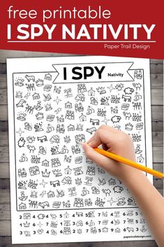 a hand holding a pencil over a printable i spy activity