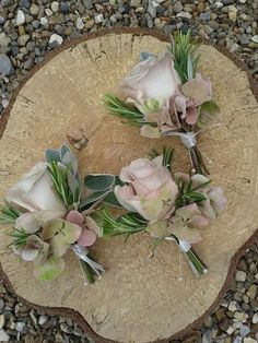 flowers are placed on top of a piece of wood