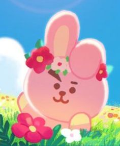 a pink bunny sitting in the grass with flowers on its head