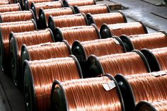 many coils of copper wire are stacked on top of each other in an assembly line