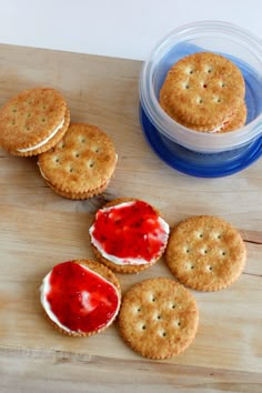 crackers and jam on a wooden cutting board