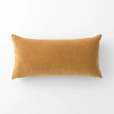 the corded pillow in caramel is shown on a white wall and has a brown cord