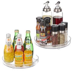 an assortment of spices and condiments are displayed on two clear trays with lids