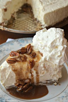 a piece of cheesecake with pecans on top