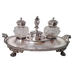 an ornate silver plate with two dishes on it