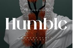 the front cover of humble magazine featuring an image of a statue with orange flowers on it