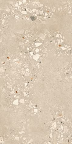 an old, dirty concrete surface with small rocks and gravel on it's sides