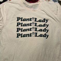 Bought As A Mystery Shirt And Not My Style. Cream Color With Dark Green Words. Never Worn Plant Lady Shirt, Plant Lady, Cream Color, Dark Green, Colorful Shirts, Womens Shirts, Womens Tops, Tops & Tees, My Style