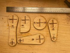 four wooden rulers are laid out on a table