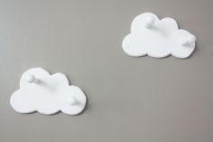 two white clouds are on the wall next to each other, one is shaped like a cloud