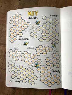 an open book with bees on it and the words may written in different languages next to each other