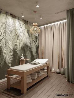 a spa room with a wooden table and white towels on the bottom shelf in front of a palm leaf wallpaper