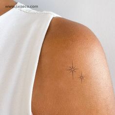 a woman with a small star tattoo on her upper arm and back shoulder, behind her is a white tank top