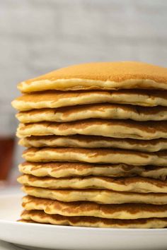 a stack of pancakes sitting on top of a white plate