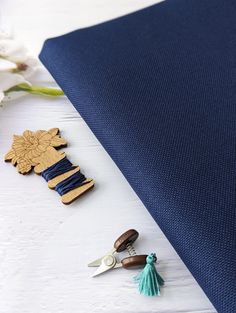 the fabric is blue and has wooden decorations on it