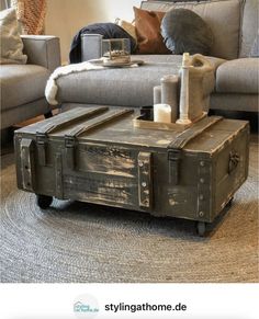 an old trunk coffee table with candles on top