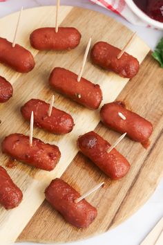 several sausages are on skewers with toothpicks