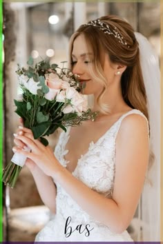 a woman in a wedding dress holding a bouquet of flowers with the words bas written on it