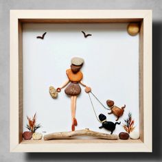 a wooden frame with a woman walking her dogs