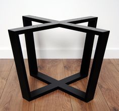 two black tables sitting on top of a wooden floor