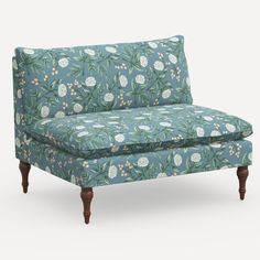 an upholstered couch with flowers and leaves on it