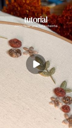 an embroidery project with flowers and leaves on it