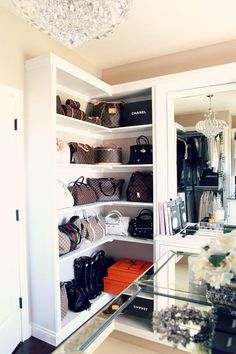 the closet is full of purses and handbags, including one in which there is a chandelier