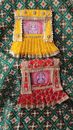 three different colored items on a green and red cloth with an image of the hindu god