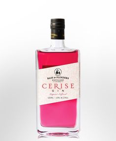 a bottle of cerise gin on a white background